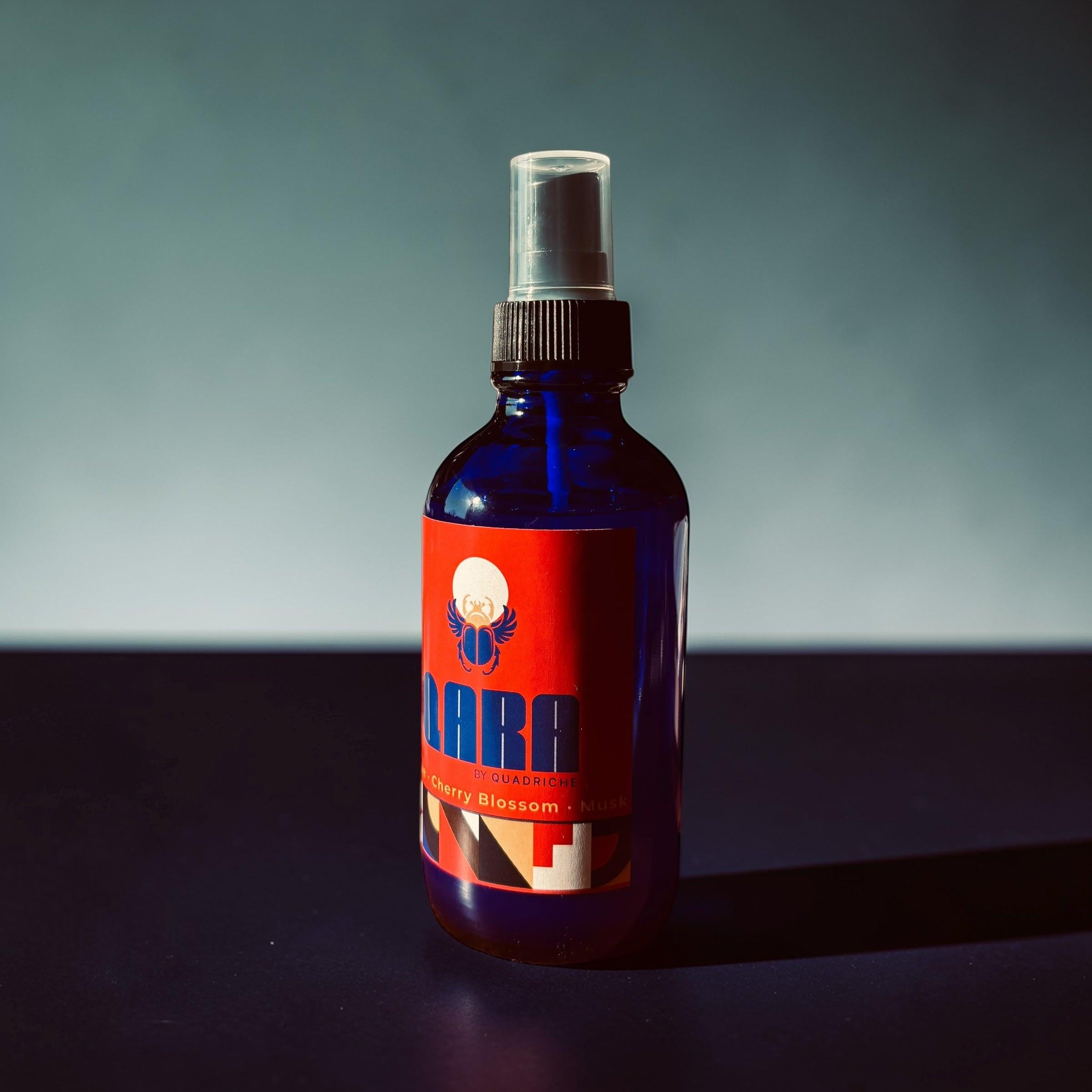 Amborisa QARA by Quadriche in cobalt blue glass spray bottle scented room & linen fragrance spray