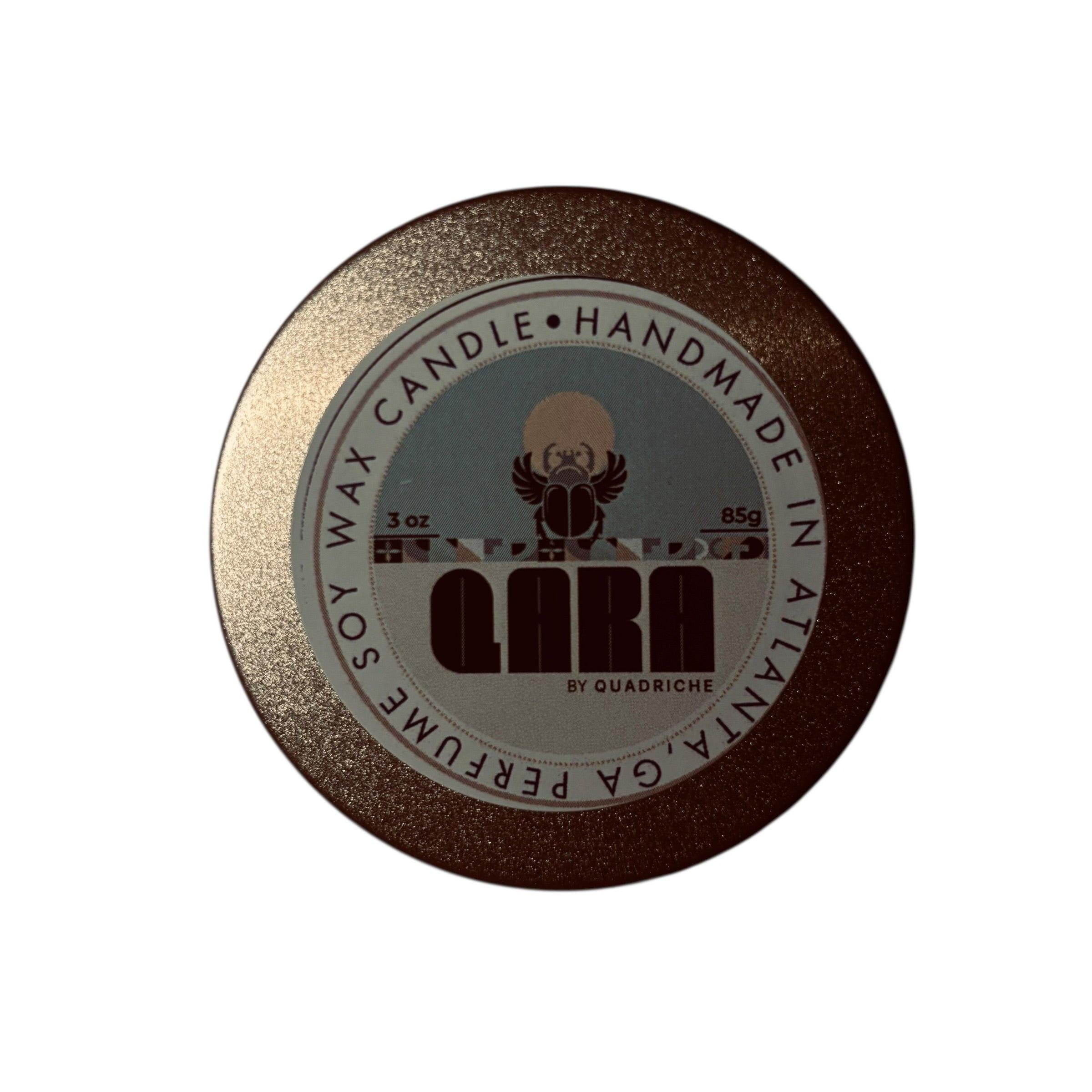 Dew Discovery Travel 3oz Candle in a tin with a round label on a wooden surface ozone apple eucalyptus scent 