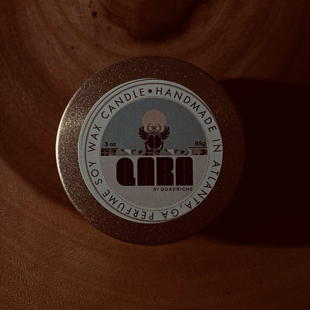 Dew Discovery Travel 3oz Candle in a champagne gold tin with a label on a wooden surface ozone apple eucalyptus scent 