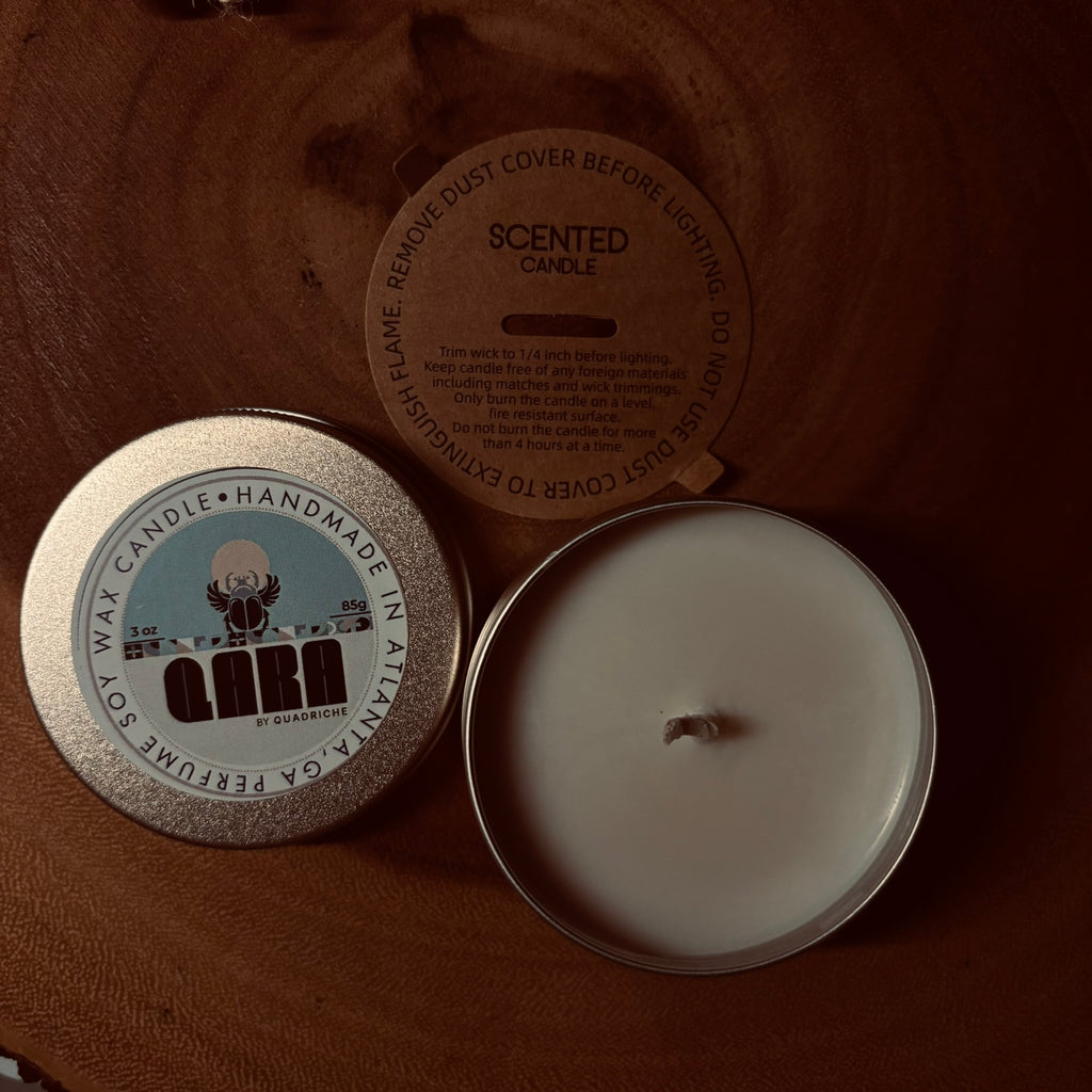Dew Discovery Travel 3oz Candle in a tin with a label on a wooden surface ozone apple eucalyptus scent 