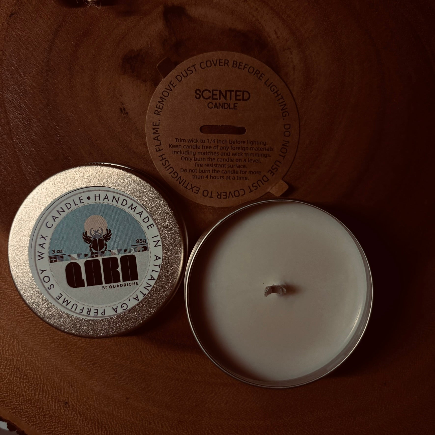 Dew Discovery Travel 3oz Candle in a tin with a label on a wooden surface ozone apple eucalyptus scent 