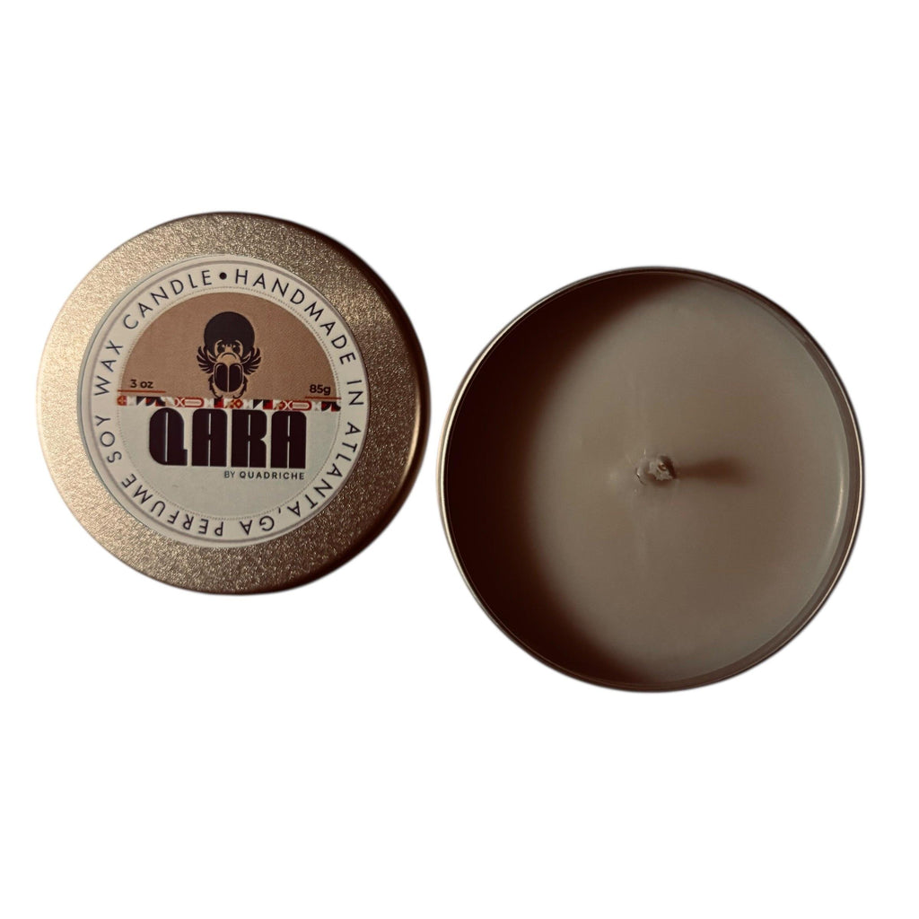 Māori Forest QARA by Quadriche Discovery Travel 3oz Candle in a tin with a label on a white surface orange amber scent 