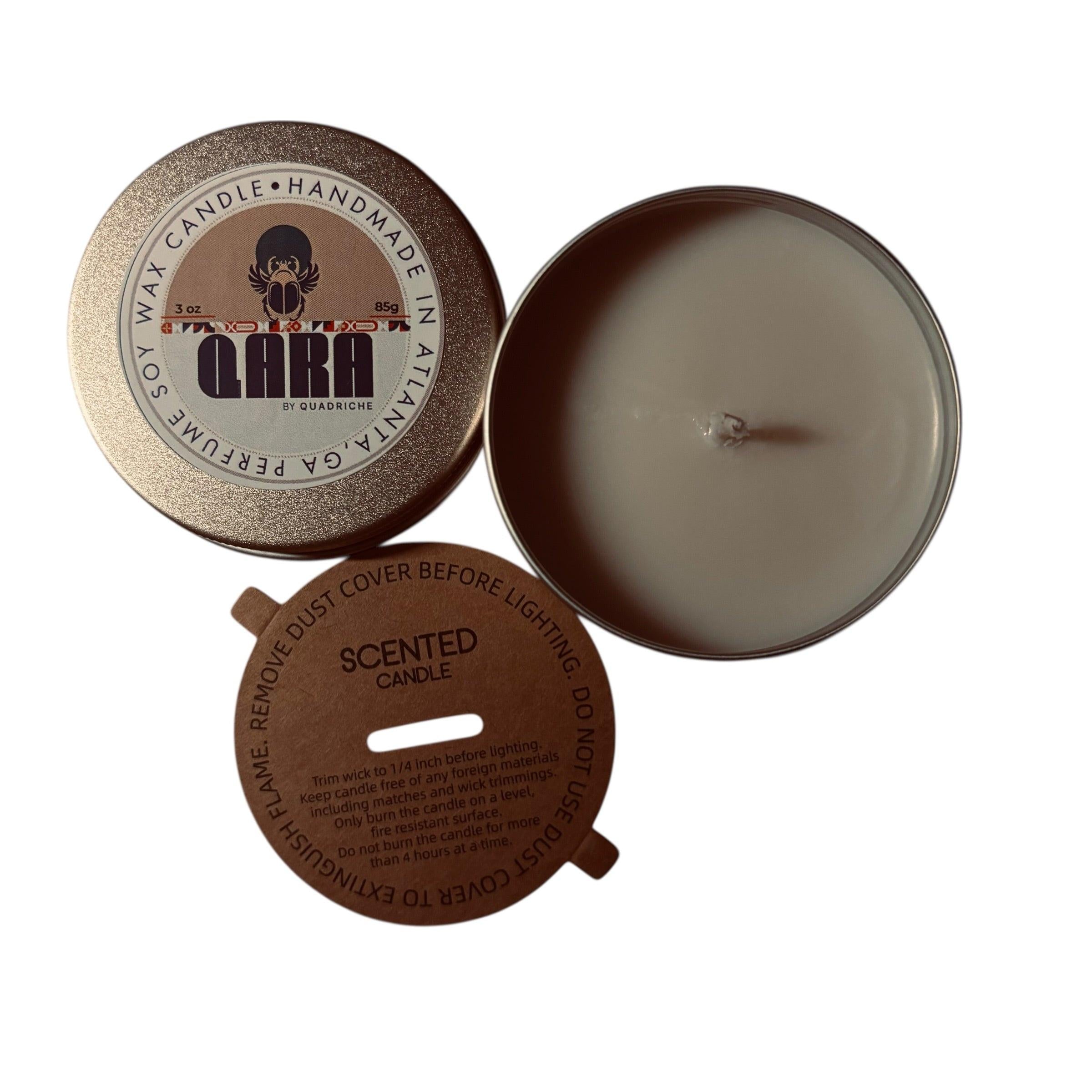 Māori Forest QARA by Quadriche Discovery Travel 3oz Candle in a tin with a label on a white surface orange amber scent 