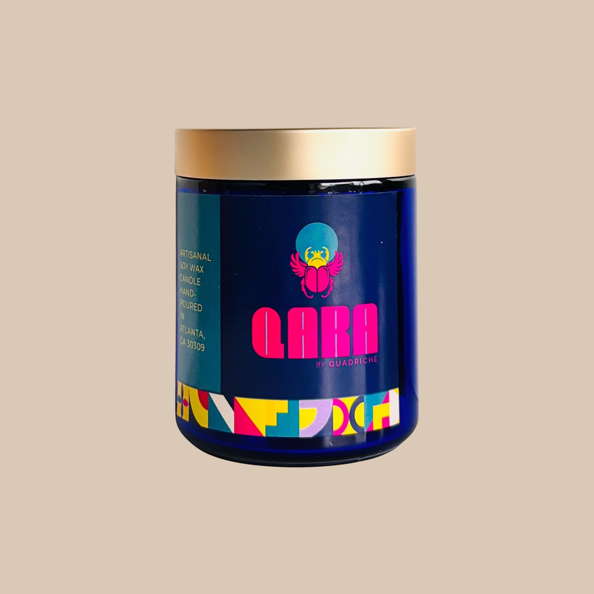 Blue container with colorful label and gold lid on beige background Festive perfume candle floral