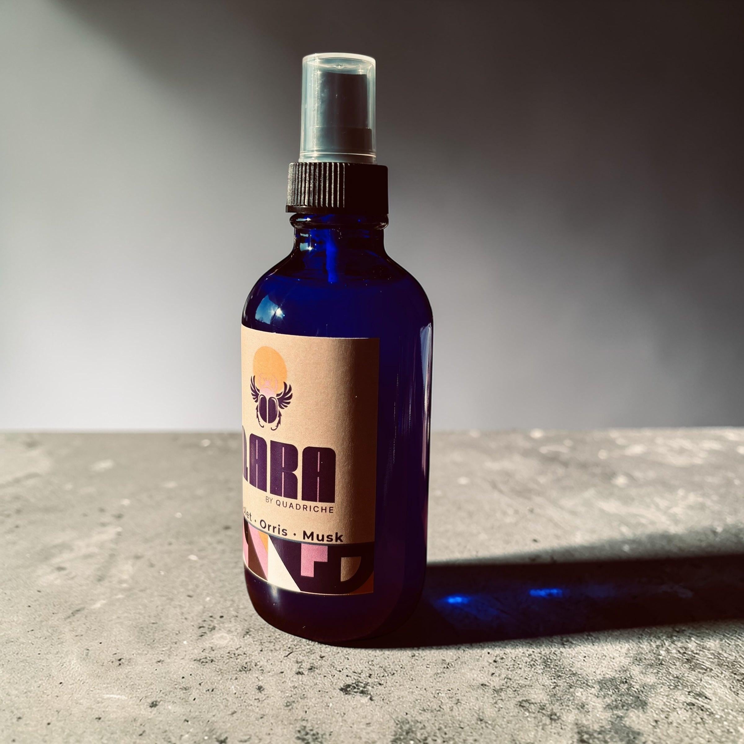 QARA by Quadriche Violet Ember Room & Linen Spray in cobalt blue glass spray bottle 