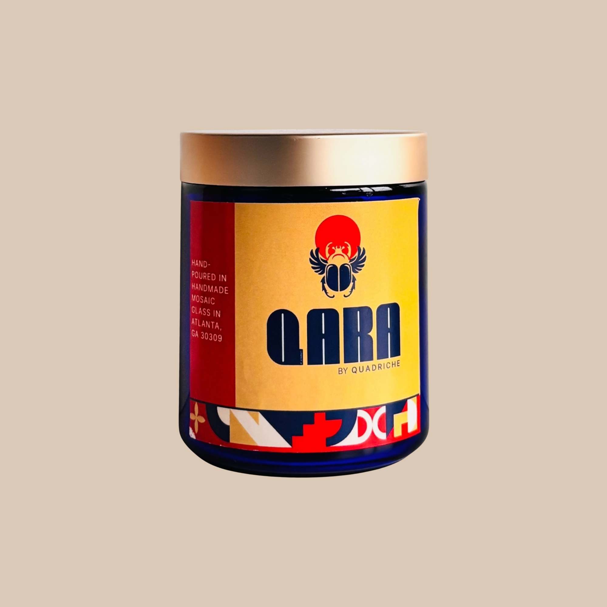 Candle jar with colorful label featuring the brand 'Qara' on a beige background