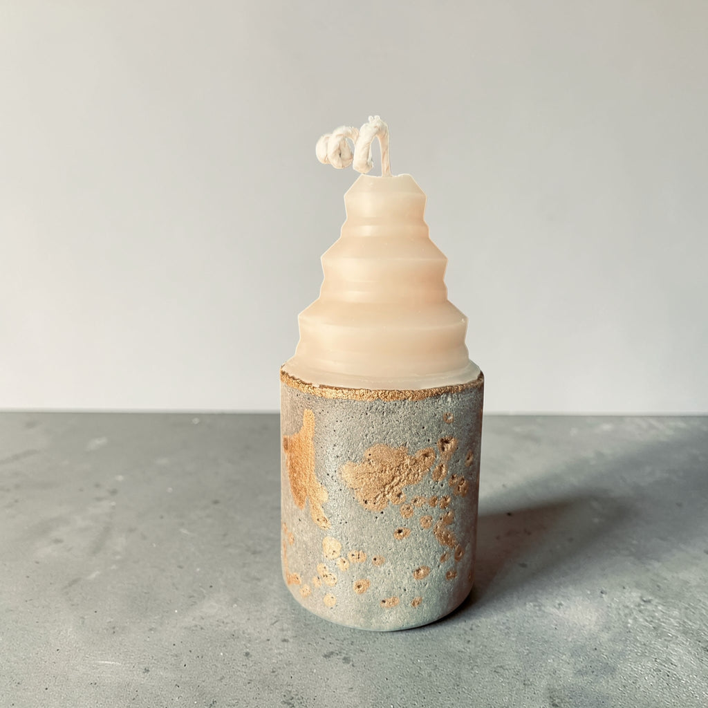 Concrete candle with low rounded shape and textured gold-accented base, mixed media soy wax and concrete candle handcrafted in Atlanta side view
