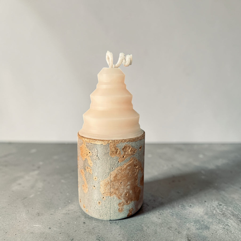 Concrete candle with low rounded shape and textured gold-accented base, mixed media soy wax and concrete candle handcrafted in Atlanta front view
