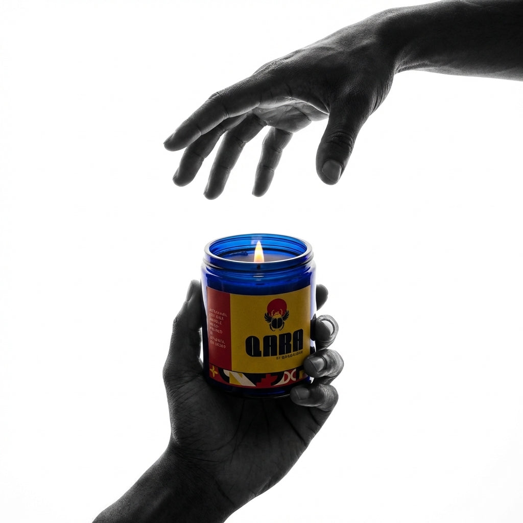 Hand holding a Quadriche soy wax natural candle with a visible brand QARA logo against a white background
