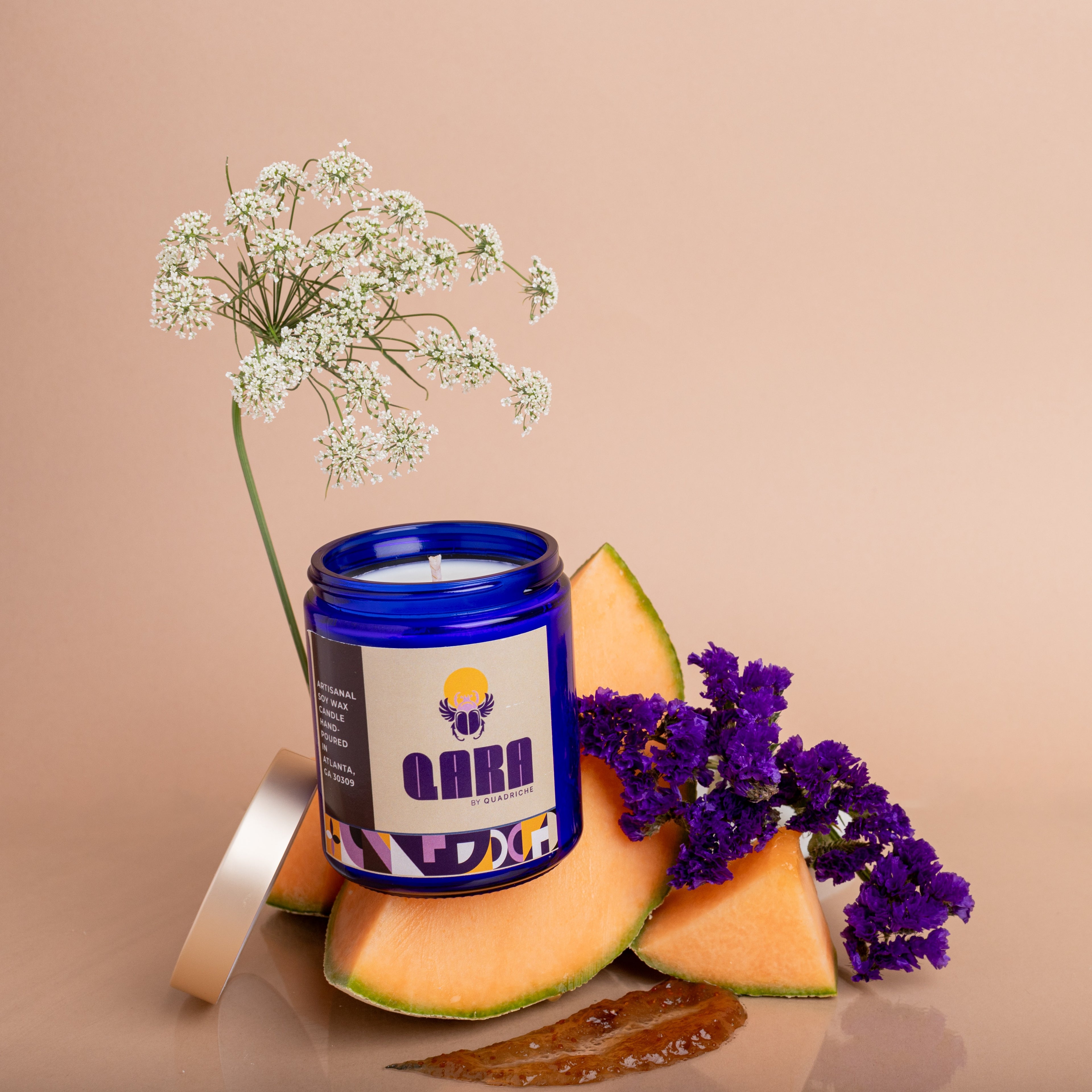Violet Ember scented soy candle in cobalt glass shown at angle – violet, amber and wood home fragrance by Quadriche Atlanta