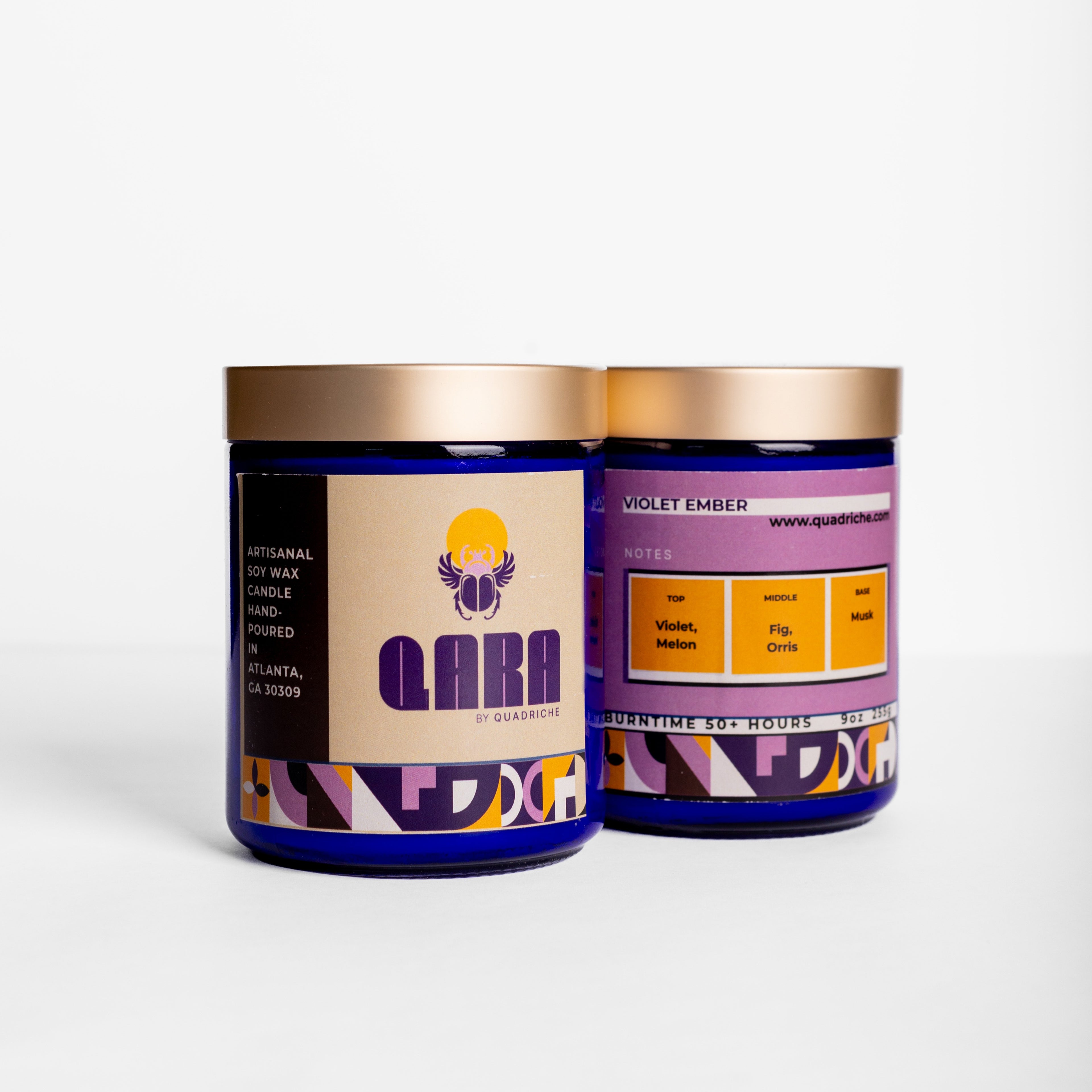 Close-up of Violet Ember candle label on cobalt glass vessel – handcrafted soy candle by Quadriche Atlanta