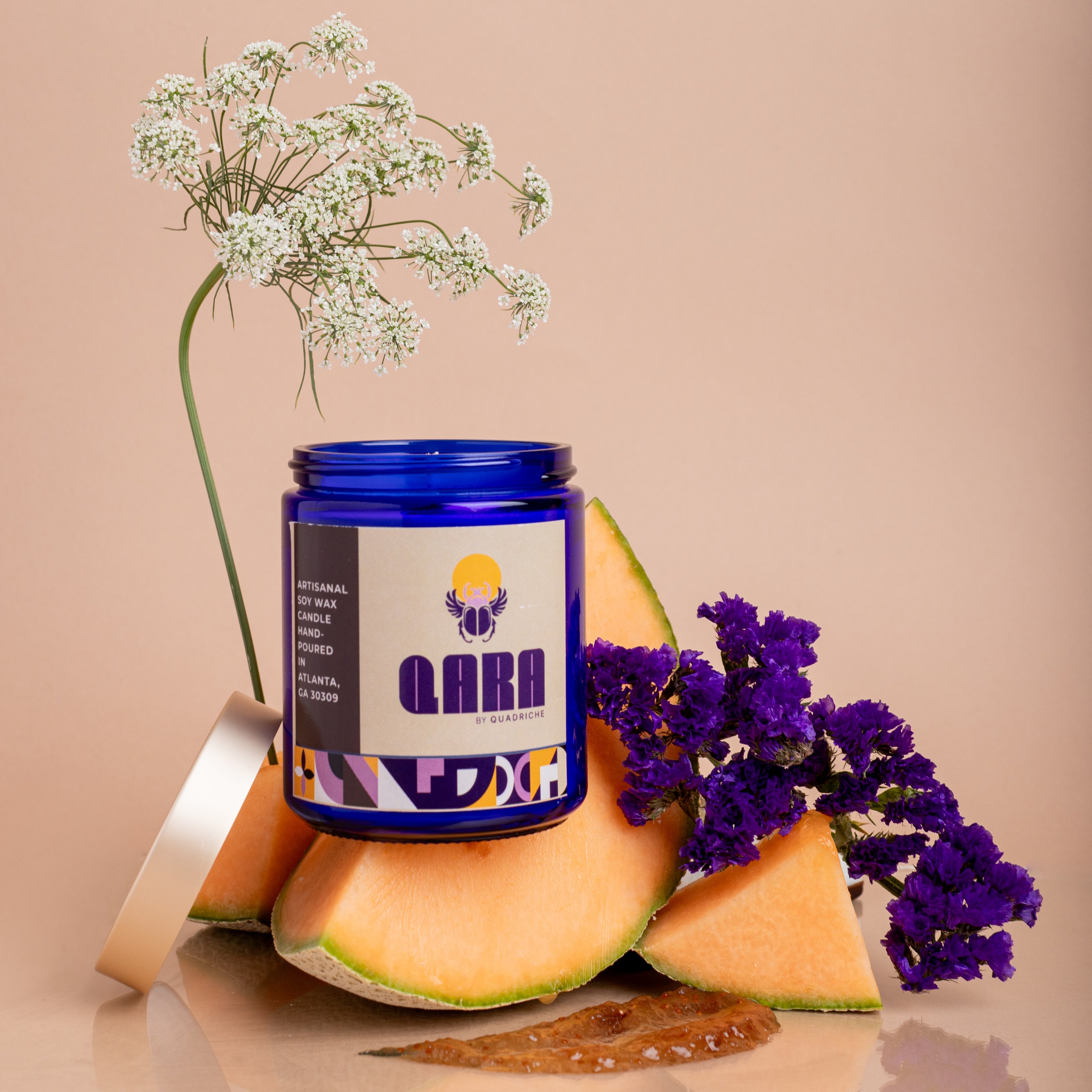 Luxury soy candle Violet Ember with violet, amber and warm wood notes in cobalt blue glass – hand poured by Quadriche Atlanta